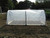 Mini polytunnel on a raised bed with a polythene cover