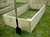 An empty raised bed before soil is added